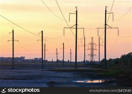 Sunset sky above the town and high-tension transmission line