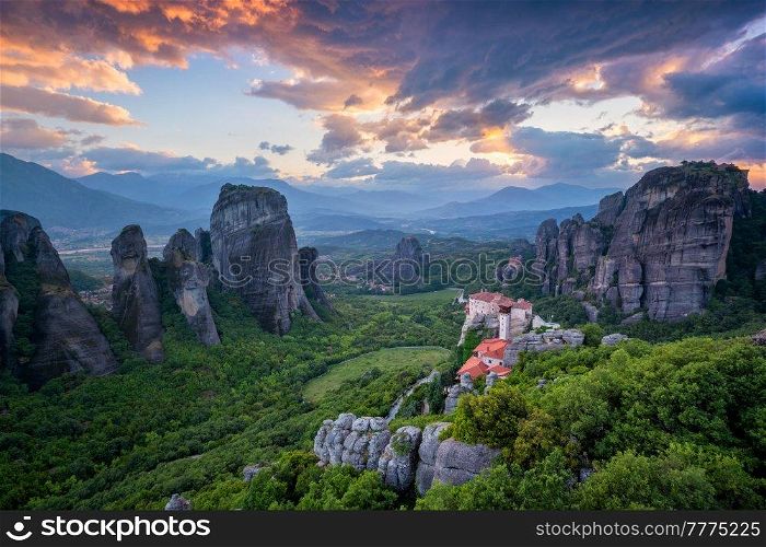 Sunset sky and monastery of Rousanou and Monastery of St. Nicholas Anapavsa in famous greek tourist destination Meteora in Greece with dramatic sky. Sunset sky and monasteries of Meteora