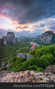 Sunset sky and monastery of Rousanou and Monastery of St. Nicholas Anapavsa in famous greek tourist destination Meteora in Greece with dramatic sky. Sunset sky and monasteries of Meteora