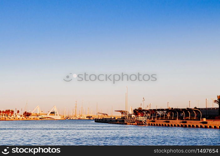 Sunset sky at Habour and promenade of La Marina de Valencia near Playa de las Arena in Valencia city - Spain