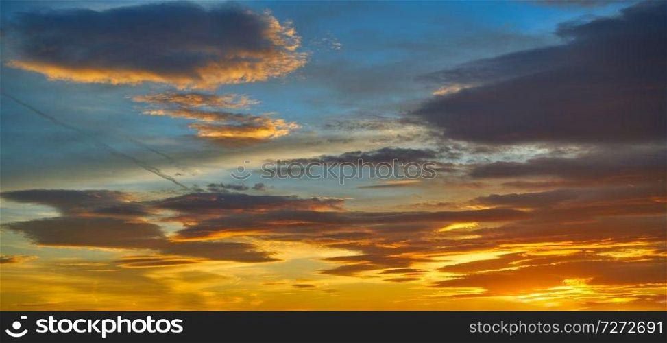 Sunset sky clouds in orange and blue background