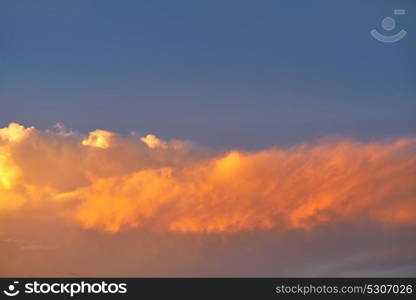 Sunset sky orange clouds on blue colorful Caribbean cloudscape