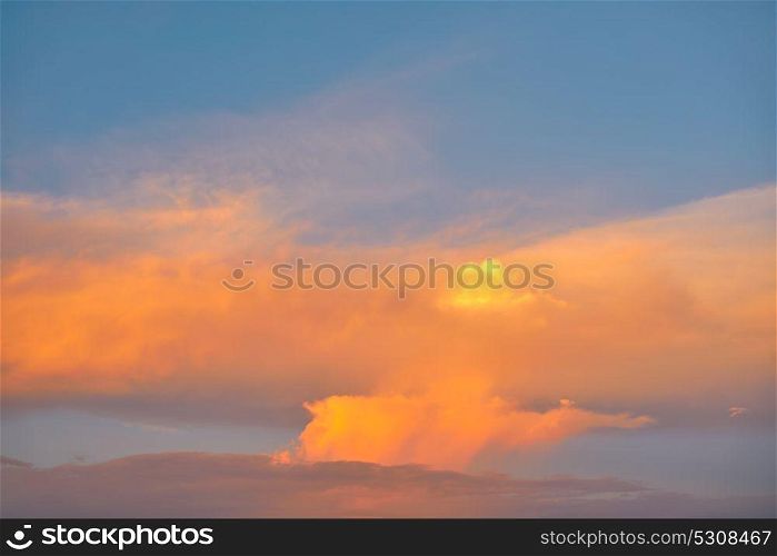 Sunset sky orange clouds on blue colorful Caribbean cloudscape
