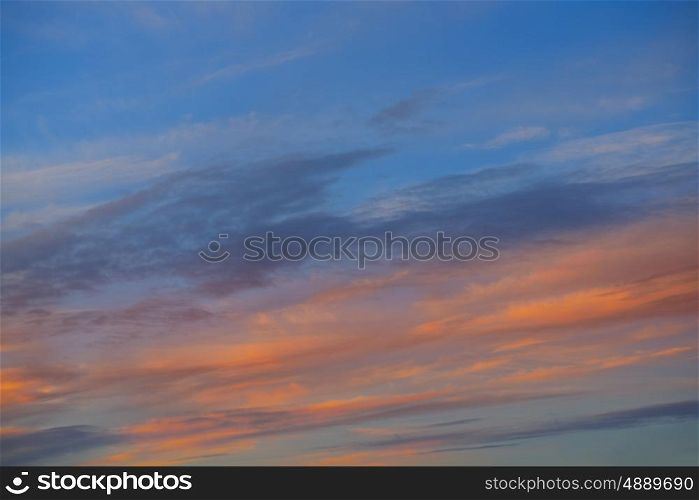 Sunset sky orange clouds over blue background