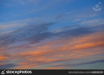 Sunset sky orange clouds over blue background