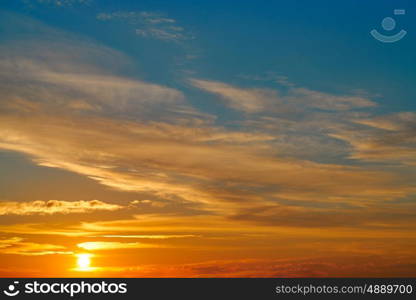 Sunset sky orange clouds over blue background