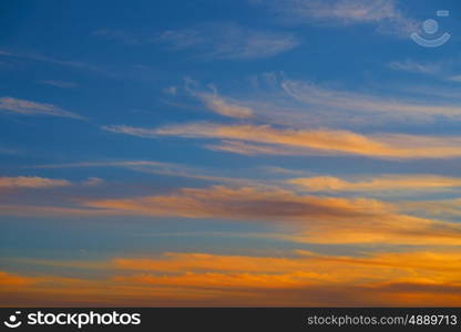 Sunset sky orange clouds over blue background