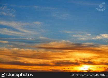Sunset sky orange clouds over blue background