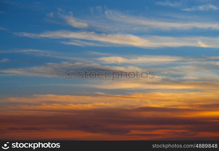 Sunset sky orange clouds over blue background