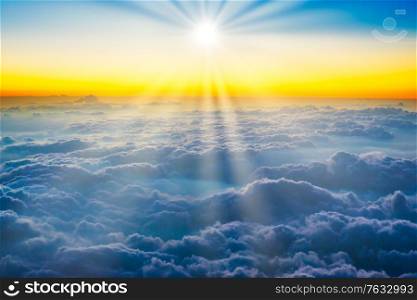 Sunset sky with blue clouds, aerial view from a plane