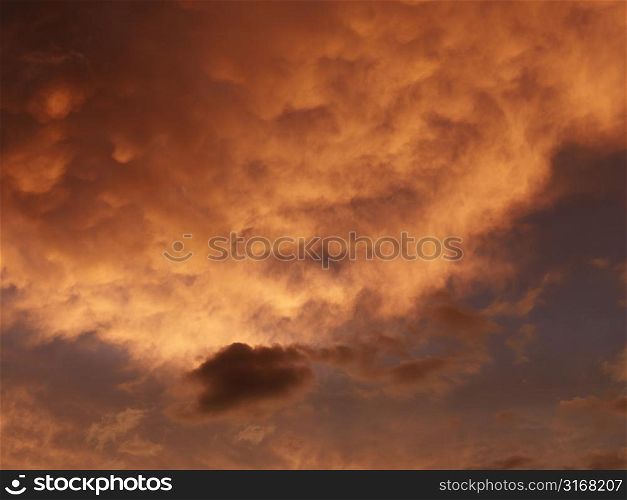 Sunset sky with orange and yellow clouds.