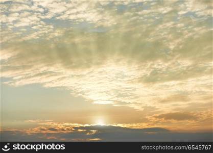 Sunset sky with orange clouds. Sunset sky with orange clouds, sun and rays as nature background
