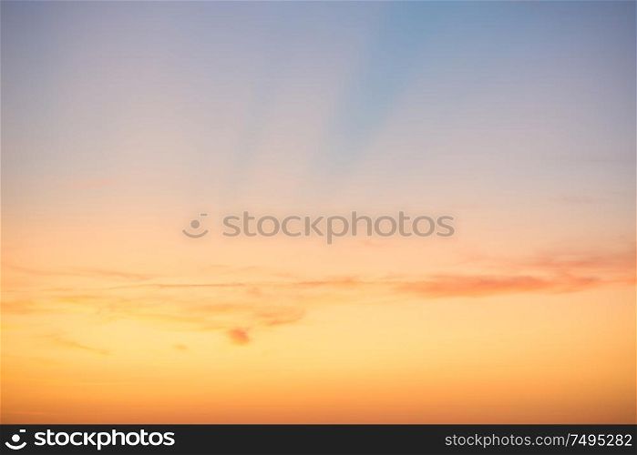 Sunset sky with red blue clouds and sun rays