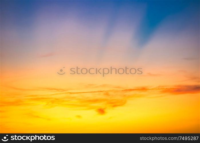 Sunset sky with red blue clouds and sun rays