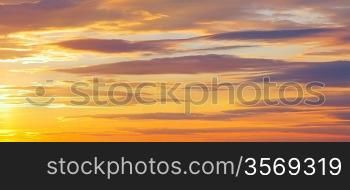 sunset sky with stratiform lighted clouds