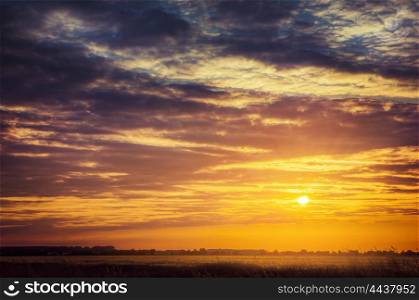 Sunset sky with sun and clouds, nature background