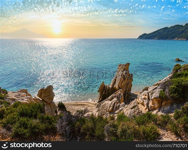 Sunset summer sandy beach and rocky coast near Platanitsi Beach, Sithonia Peninsula, Chalcidice, Greece.