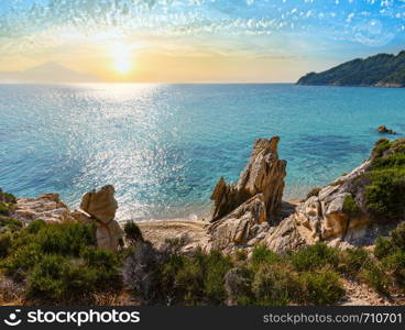 Sunset summer sandy beach and rocky coast near Platanitsi Beach, Sithonia Peninsula, Chalcidice, Greece.