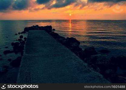 Sunset - sunrise by the sea on the beach. Beautiful romantic landscape with nature.