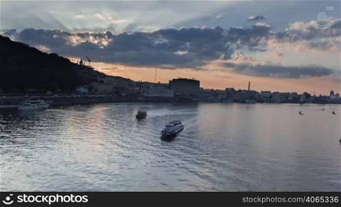 Sunset timelapse in Kyiv on Dnipro river with boats