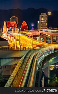 Sunset twilight monorail track and highway red bridge to Kobe downtown Hyogo Kansai Japan