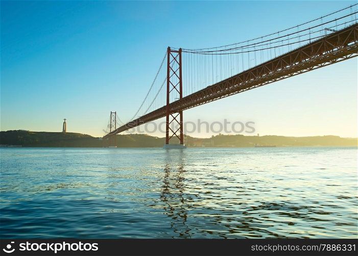 Sunset view of 25th of April Bridge in Lisbon, Portugal