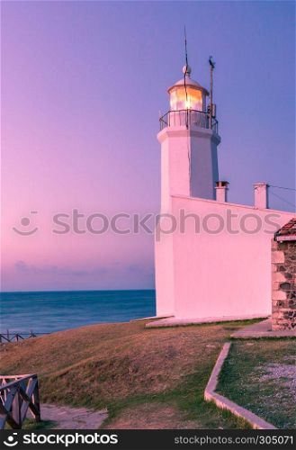 Sunset view of old white Inceburun lighthouse on the north coast of Sinop,Turkey.. Landscape view of old white Inceburun lighthouse