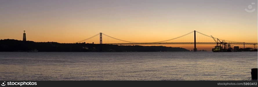 Sunset view of The 25 de Abril Bridge in Lisbon, Portugal, panorama&#xA;