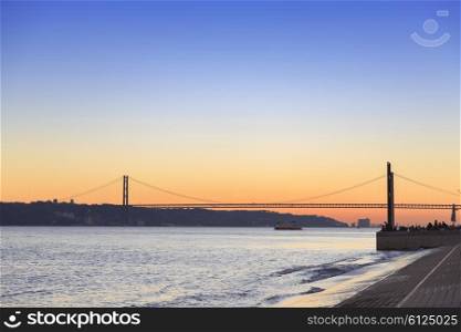 Sunset view of The 25 de Abril Bridge in Lisbon, Portugal, panorama&#xA;