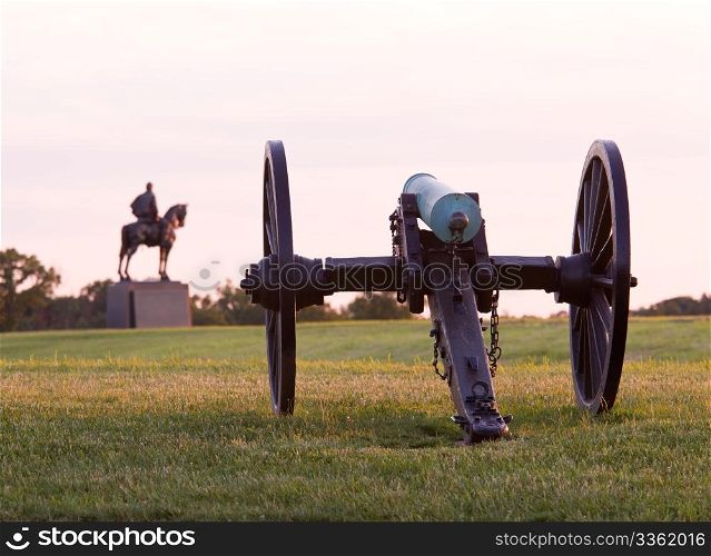 Sunset view of the old cannons in a line at Manassas Civil War battlefield where the Bull Run battle was fought. Stonewall Jackson statue is in the distance. 2011 is the sesquicentennial of the battle