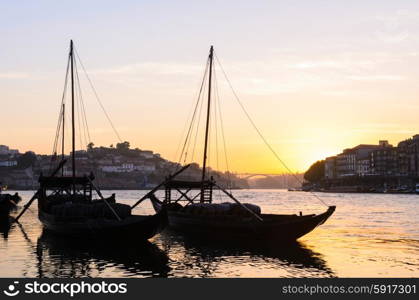 sunset view of traditional boats and Douro river in Porto, Portugal