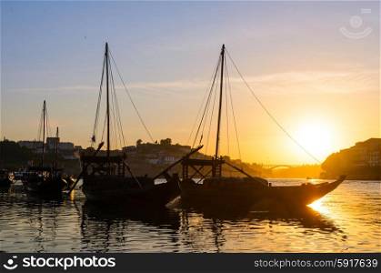 sunset view of traditional boats and Douro river in Porto, Portugal