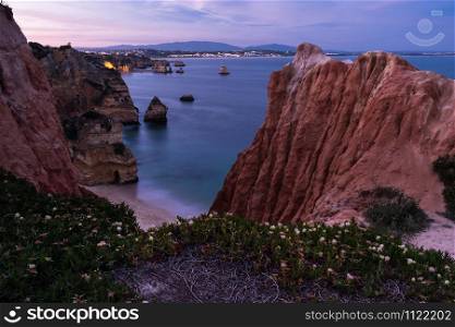 Sunset viewed from above rocky coast of Lagos, Algarve, Portugal
