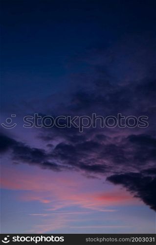Sunset with a colorful sky in orange, purple and dark blue, Vertical twilight in the evening with a beautiful dusk sky sunlight in Autumn