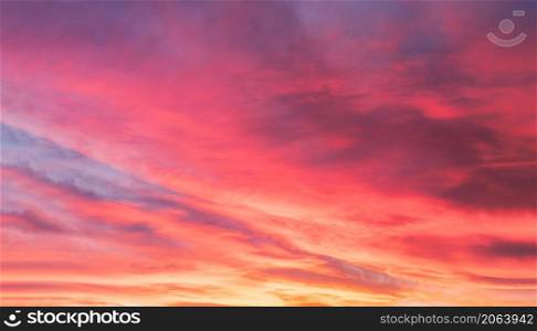 Sunset with a colorful sky in orange, yellow, purple and pink, Holizontal twilight in the evening with a beautiful dusk sky sunlight in Winter at English countryside, Image of nature for Holiday banner background