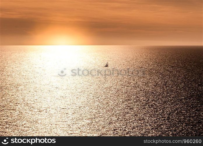 sunset with a small sailboat