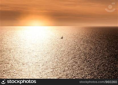 sunset with a small sailboat