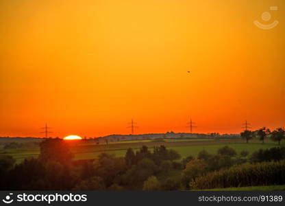 sunset with afterglow and power mast