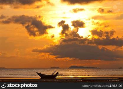 Sunset with boat and islands in the sea