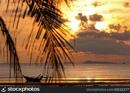 Sunset with boat in the sea, defocused palm tree on Koh Samui, Thailand&#xA;