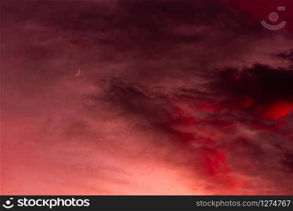 Sunset with dramatic sky and colorful clouds and moon. Sunset over forest with dramatic sky with moon