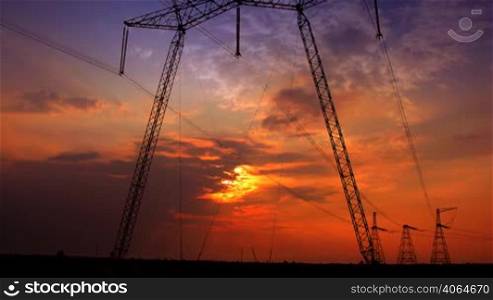 sunset with electricity pylon. time lapse.