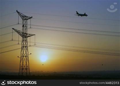Sunset with pylon and airplane