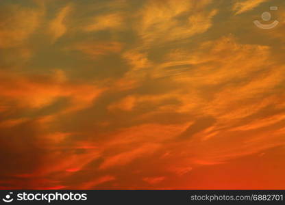 sunset with reddish yellow clouds. dark sunset with reddish yellow clouds in the sun beams