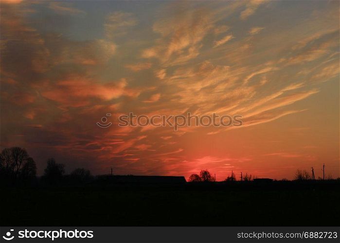 sunset with reddish yellow clouds. dark sunset with reddish yellow clouds in the sun beams