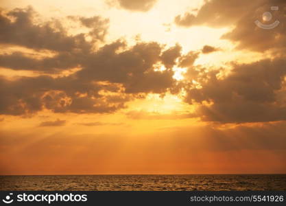 Sunset with sun rays and clouds in the sea&#xA;