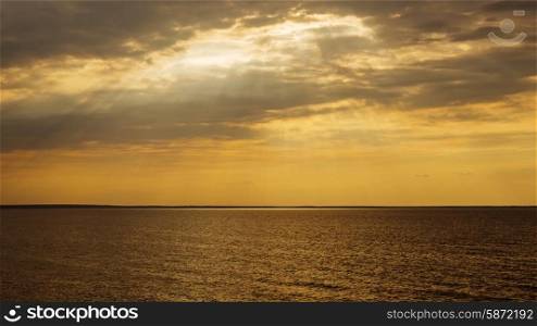 Sunset with sun rays and clouds in the sea&#xA;