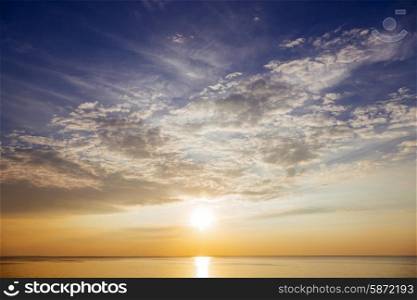 Sunset with sun rays and clouds in the sea&#xA;