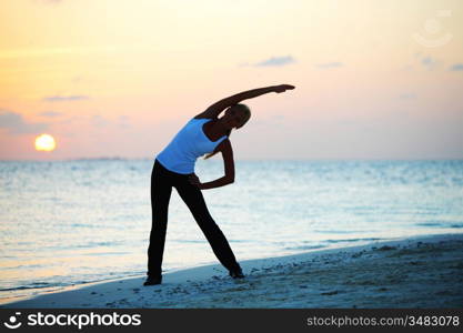 sunset yoga woman on sea coast