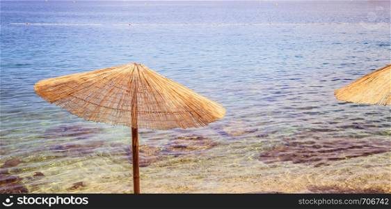 Sunshade and clear water on the beach, Lone Bay, Croatia